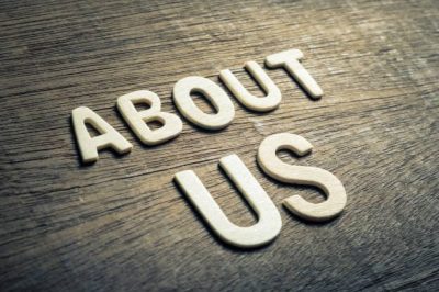 ABOUT US concept by wood alphabets arranged on wood background ABOUT US concept by wood alphabets arranged on wood background